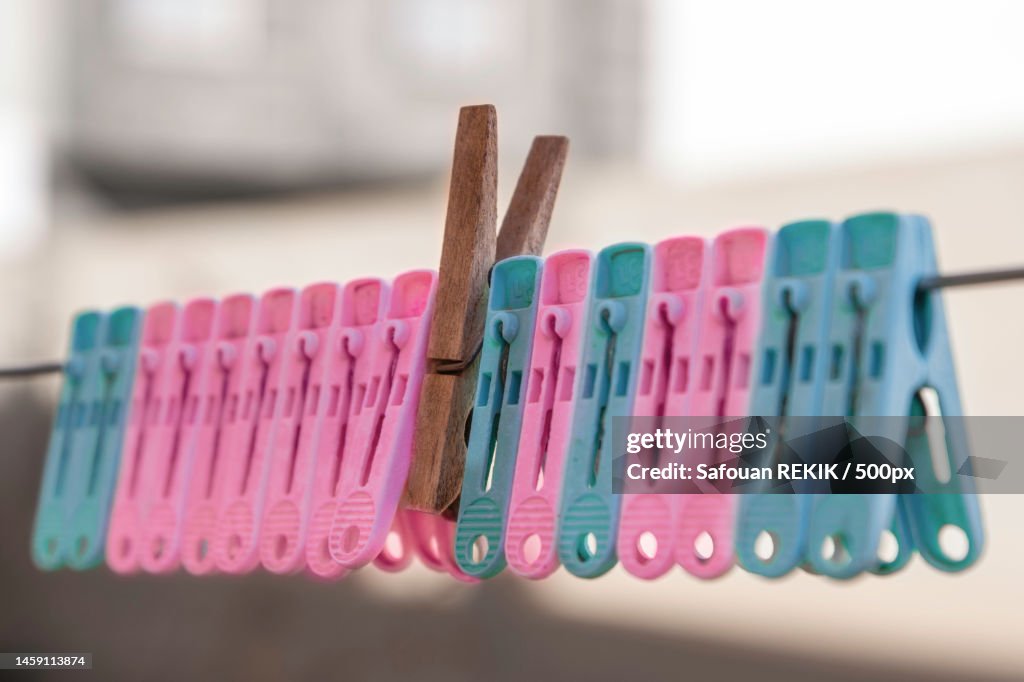 Close-up of clothespins hanging on clothesline
