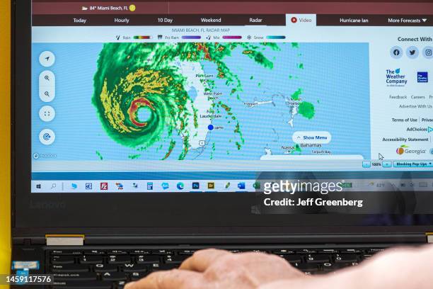 Miami Beach, Florida, laptop screen showing Radar of Hurricane Ian, category 4 storm, eye and feeder bands in Gulf of Mexico approaching landfall.