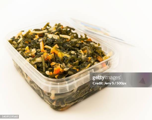 seafood salad with laminaria seaweeds and calamaries packed plastic container,isolated - packed lunch - fotografias e filmes do acervo