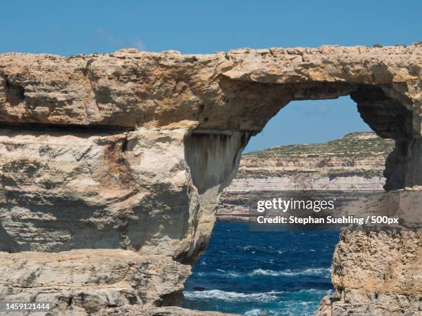 view of rock formation against clear sky,gozo,malta - azure window malta stock pictures, royalty-free photos & images