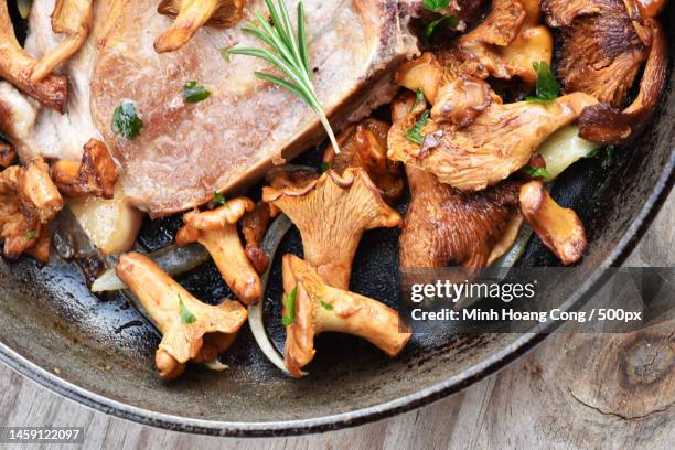 high angle view of meat in plate on table,france - cantharellus cibarius stock pictures, royalty-free photos & images