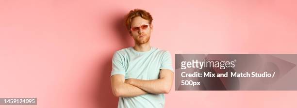 tourism and vacation concept sassy redhead guy in sunglasses,cross - sassy shades foto e immagini stock