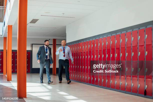 walking between classes - school teacher success bildbanksfoton och bilder