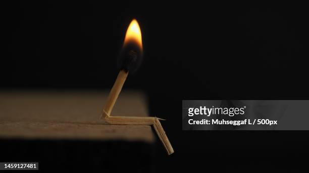 close-up of burning matchstick against black background,indonesia - matchstick ignition stock pictures, royalty-free photos & images