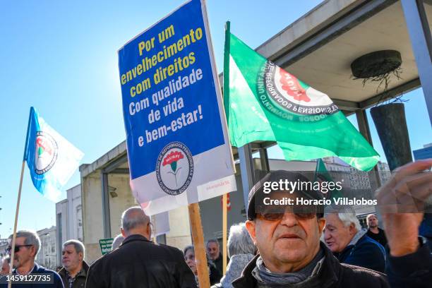 Pensioners hold posters and flags while gathering to protest in Alameda Dom Afonso Henriques against the rising cost of living on January 24 in...