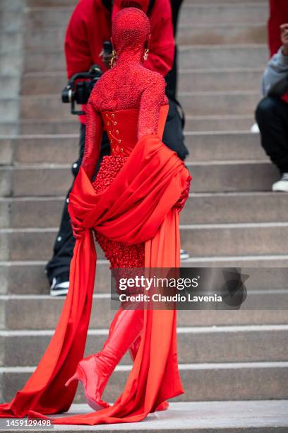 Doja Cat wears a red Schiaparelli total look and red makeup all over the body, outside Schiaparelli, during Paris Fashion Week - Menswear Fall-Winter...