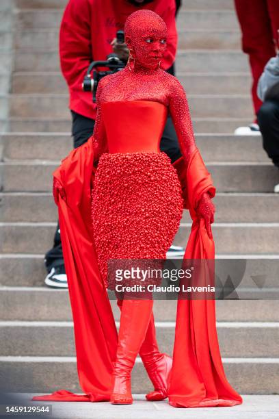 Doja Cat wears a red Schiaparelli total look and red makeup all over the body, outside Schiaparelli, during Paris Fashion Week - Menswear Fall-Winter...