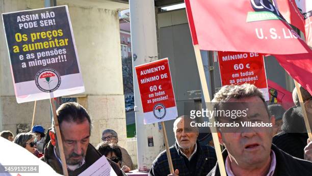 Pensioners hold posters and flags while gathering to protest in Alameda Dom Afonso Henriques against the rising cost of living on January 24 in...