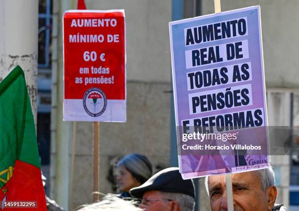 Pensioners hold posters and flags while gathering to protest in Alameda Dom Afonso Henriques against the rising cost of living on January 24 in...