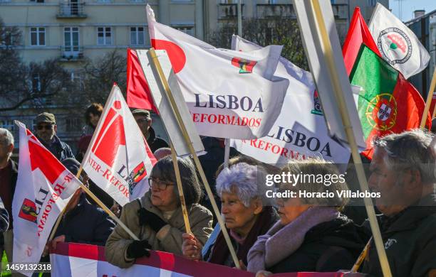 Pensioners hold posters and flags while gathering to protest in Alameda Dom Afonso Henriques against the rising cost of living on January 24 in...