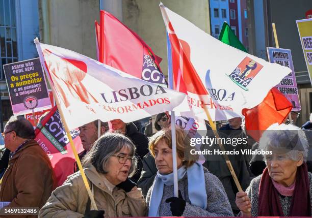 Pensioners hold posters and flags while gathering to protest in Alameda Dom Afonso Henriques against the rising cost of living on January 24 in...