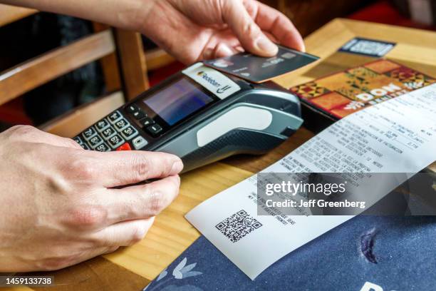 Bogota, Colombia, La Candelaria, Centro Historico, historic district, Don Benitez Mexican Grill restaurant, waiter swiping credit card scanner,...