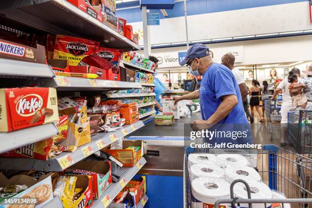 North Miami Beach, Florida, Walmart discount department store, checkout line, customer paying buying paper towels, candy aisle.