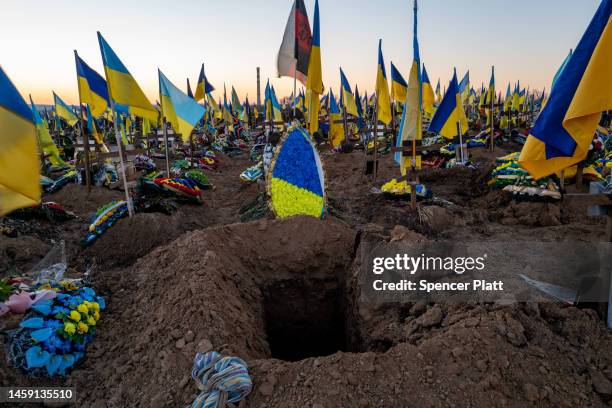 Ukrainian flags are placed on the graves of soldiers at a Khrakiv cemetery on January 24, 2023 in Kharkiv, Ukraine. Nearly one year after Russian...