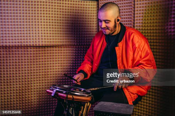 young man playing electronic portable drums in the studio - hitting drum stock pictures, royalty-free photos & images