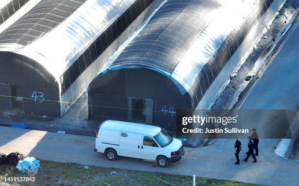 In an aerial view, San Mateo County sheriff deputies walk through a farm where a mass shooting occurred on January 24, 2023 in Half Moon Bay,...