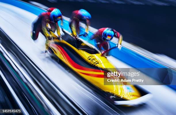 Francesco Friedrich, Thorsten Margis, Candy Bauer and Alexander Schueller of Team Germany slide during the four-man Bobsleigh heats on day 15 of...