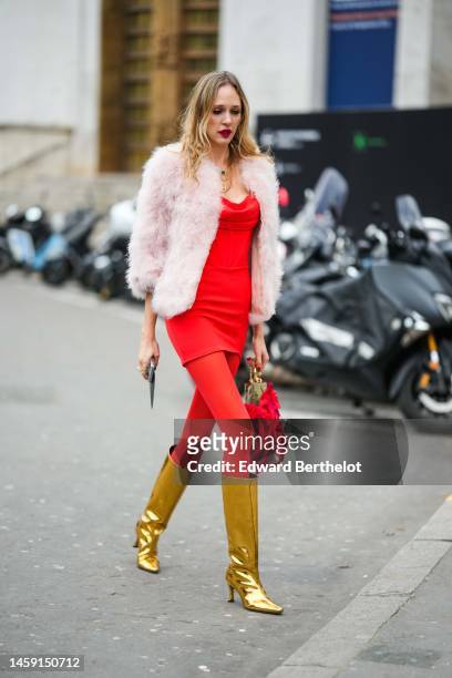 Guest wears gold pendant earrings, a neon red corset V-neck short tube dress, red tights, a pale pink fur coat, a red flower print pattern large...