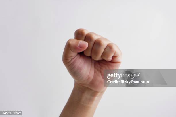 arm and fist against white background - poing photos et images de collection