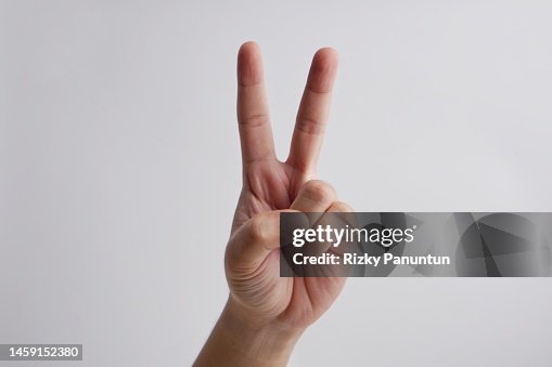 Close-up of male hand doing "peace" sign Close-up of male hand doing "peace" sign