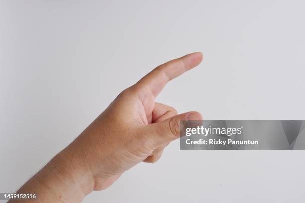 cropped hand of person pointing against white background - index finger stock pictures, royalty-free photos & images