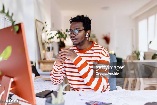 man on a video conference call at home office - online class stock pictures, royalty-free photos & images