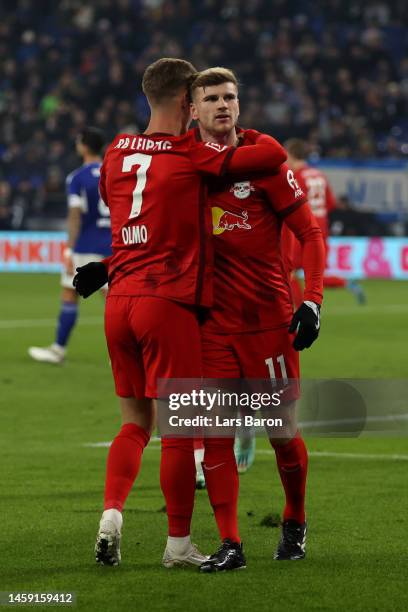 Timo Werner of RB Leipzig celebrates with teammate Dani Olmo after scoring the team's fourth goal during the Bundesliga match between FC Schalke 04...