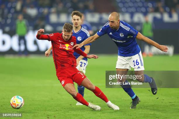 Dani Olmo of RB Leipzig battles for possession with Michael Frey and Cedric Brunner of FC Schalke 04 during the Bundesliga match between FC Schalke...