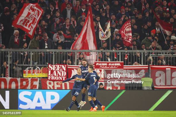 Ellyes Skhiri of 1.FC Koln celebrates with teammates after scoring the team's first goal during the Bundesliga match between FC Bayern München and 1....