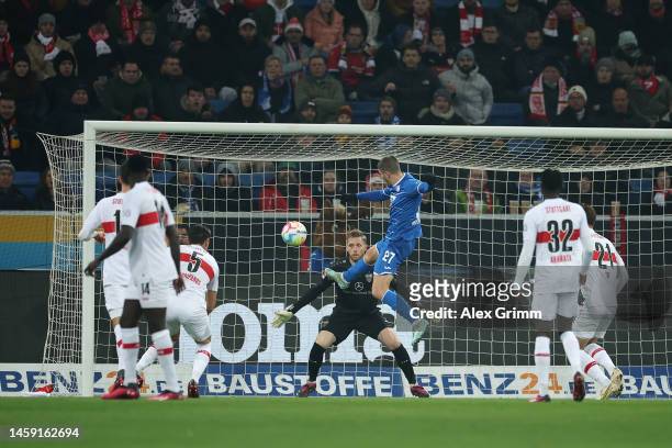Andrej Kramaric of TSG Hoffenheim scores the team's first goal as Florian Muller of VfB Stuttgart attempts to make a save during the Bundesliga match...
