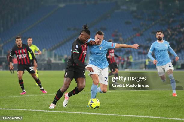 Rafael Leao of AC Milan is challenged by Adam Marusic of SS Lazio during the Serie A match between SS Lazio and AC Milan at Stadio Olimpico on...