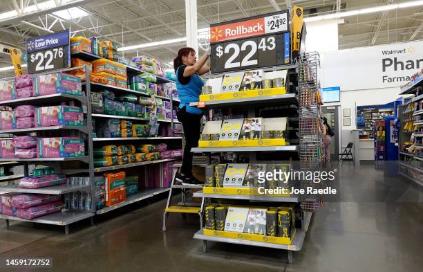 Worker stocks the shelves at a Walmart store on January 24, 2023 in Miami, Florida. Walmart announced that it is raising its minimum wage for store...