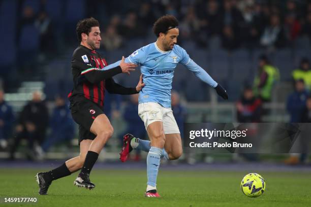 Felipe Anderson of SS Lazio is challenged by Davide Calabria of AC Milan during the Serie A match between SS Lazio and AC Milan at Stadio Olimpico on...