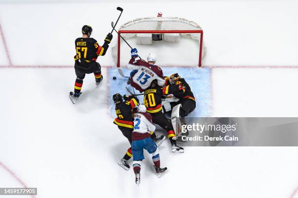 Tyler Myers Quinn Hughes Elias Pettersson and Collin Delia of the Vancouver Canucks defend against Valeri Nichushkin and Artturi Lehkonen of the...