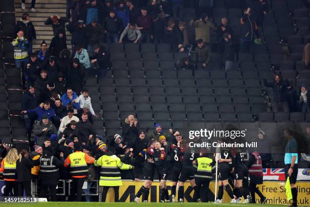 Tom Bayliss of Shrewsbury Town celebrates with teammates and fans after scoring the team's first goal during the Sky Bet League One match between...