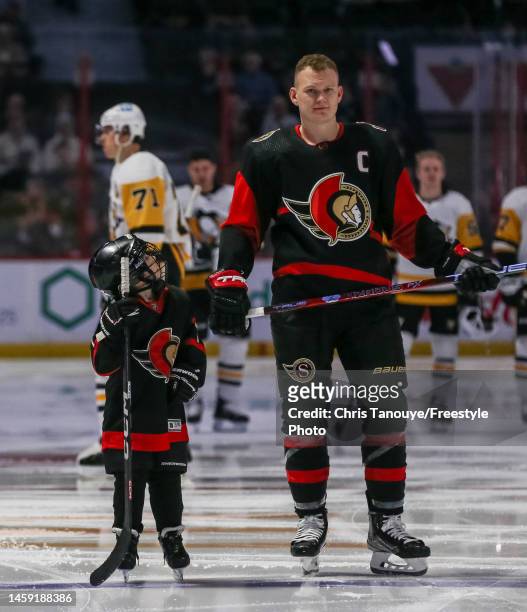 Make A Wish Kid, Daniel Maloney, stands with Brady Tkachuk of the Ottawa Senators during player introductions prior to an NHL game against the...