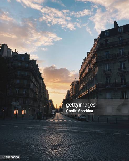 empty city street at sunset, paris, france - paris street stock pictures, royalty-free photos & images