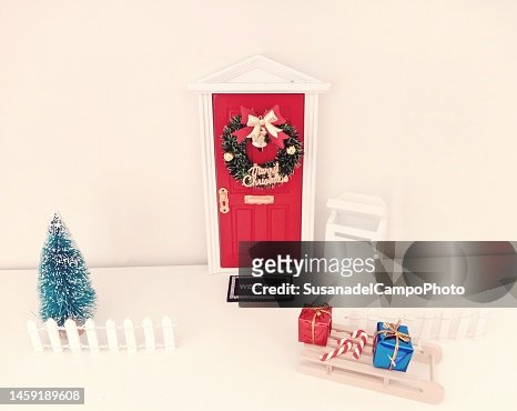 Miniature Christmas Decorations Leaning Against A Wall To Look Like A House  Entrance High-Res Stock Photo - Getty Images