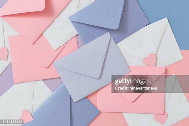 full frame overhead view of assorted pastel coloured envelopes and heart shaped stickers - love letter stock pictures, royalty-free photos & images