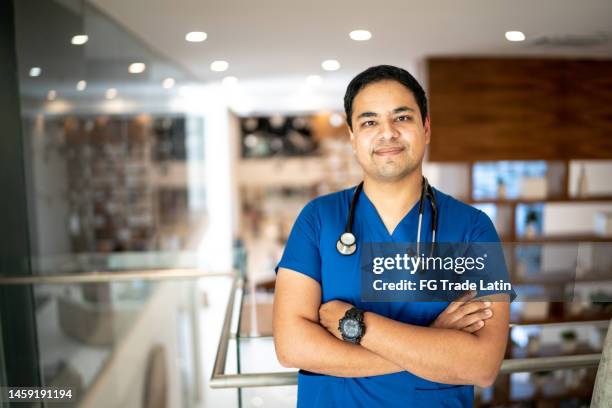 portrait of mid adult nurse man at hospital - nurse headshot stock pictures, royalty-free photos & images