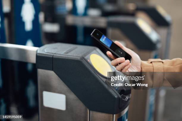 close-up of young business woman paying at subway station with smartphone - train ticket stock pictures, royalty-free photos & images
