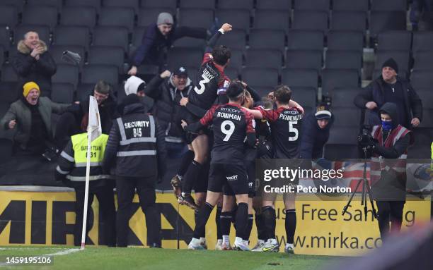 Shrewsbury Town players celebrate with fans after Tom Bayliss had scored his sides winning goal during the Sky Bet League One between Milton Keynes...