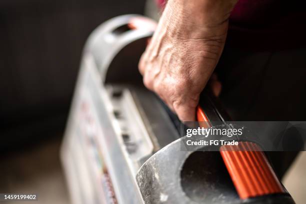 close-up of a senior man holding a tool box - plumber stock pictures, royalty-free photos & images