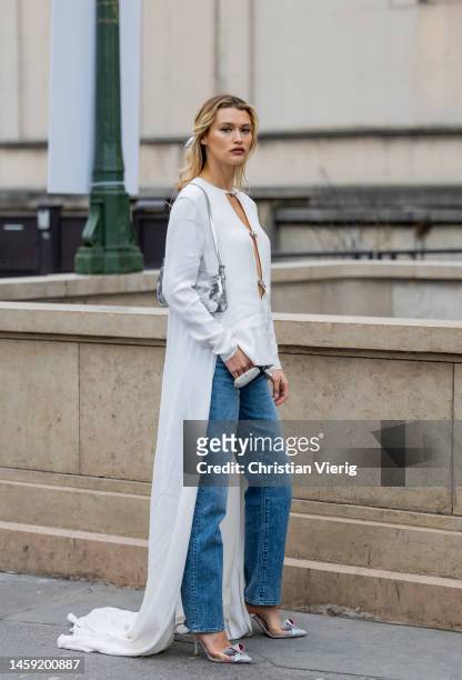 Chloe Lecareux wears white blouse, denim jeans outside Stéphane Rolland during Paris Fashion Week - Haute Couture Spring Summer : Day Two on January...