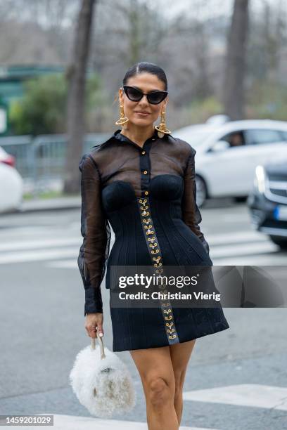 Guest wears black see trough dress outside Alexis Mabille during Paris Fashion Week - Haute Couture Spring Summer : Day Two on January 24, 2023 in...