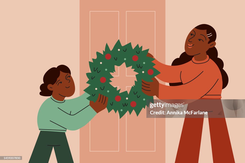A Brother and Sister Work Together to Decorate Their Front Door with a Christmas Wreath
