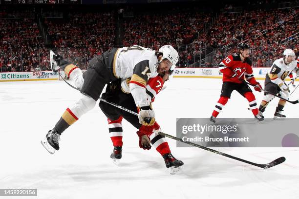 Jonas Siegenthaler of the New Jersey Devils gets the hip into Nicolas Hague of the Vegas Golden Knights during the first period at the Prudential...