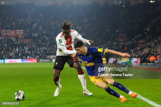 Mohammed Salisu of Southampton FC and Miguel Almirón of Newcastle United FC jostles for the ball during the Carabao Cup Semi Final 1st Leg match...