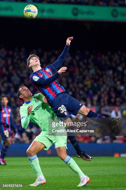 Pablo Paez 'Gavi' of FC Barcelona competes for the high ball with Angel Algobia of Getafe CF during the LaLiga Santander match between FC Barcelona...