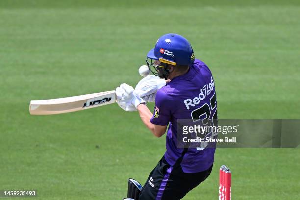 Caleb Jewell of the Hurricanes is struck by the ball during the Men's Big Bash League match between the Hobart Hurricanes and the Brisbane Heat at...